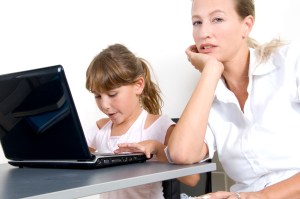 mother and daughter working on laptop
